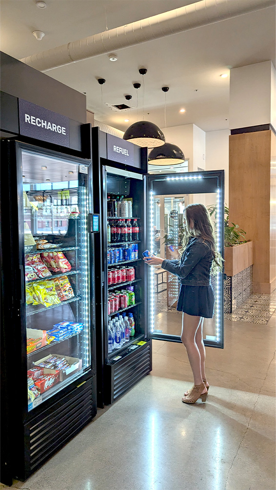 mm-local-side Woman getting a drink from a vending machine