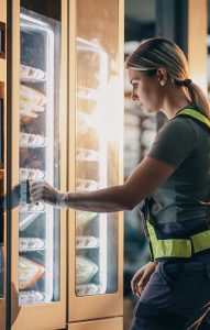 Warehouse worker buying from a smart vending machine